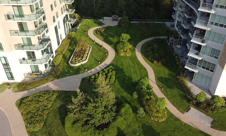 Freshly maintained lawn and garden beds outside a commercial property in summer
